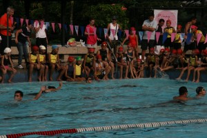 Visually Impaired kids swimming as the other kids cheer them on